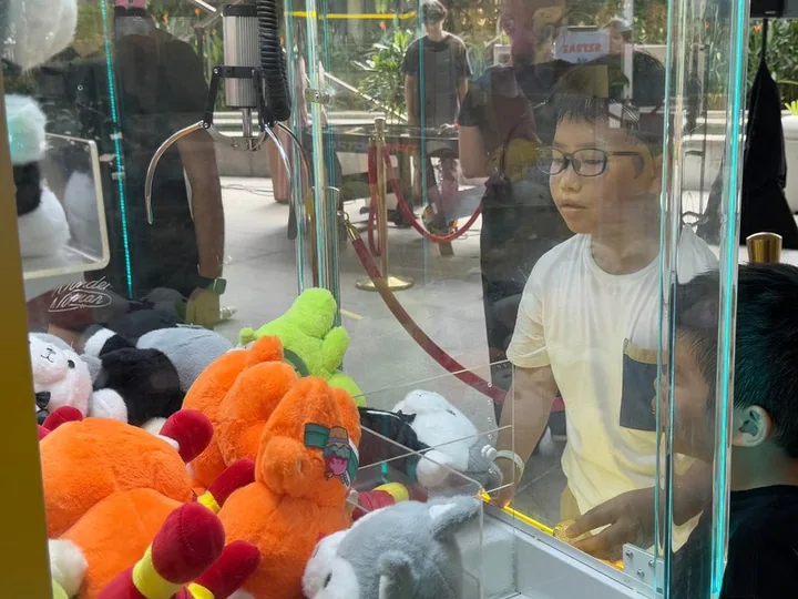 A guest playing a claw machine