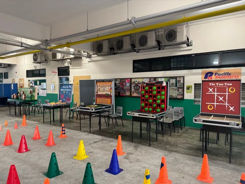 Carnival game booths set up indoors by BounceParkSG