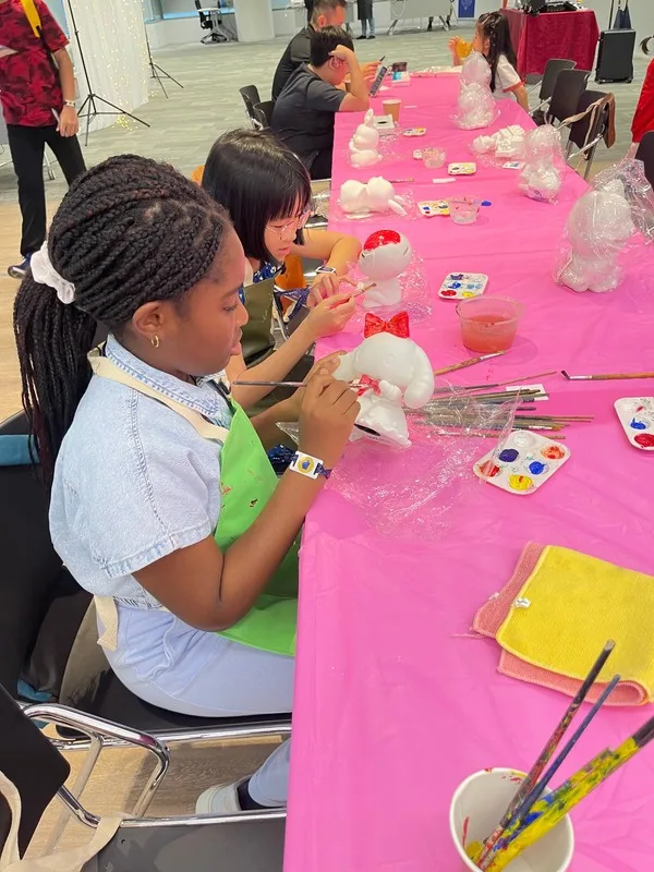 A child painting a soft toy