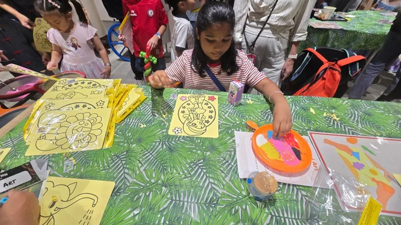 A child colouring a kite at a kids-at-work day by BounceParkSG