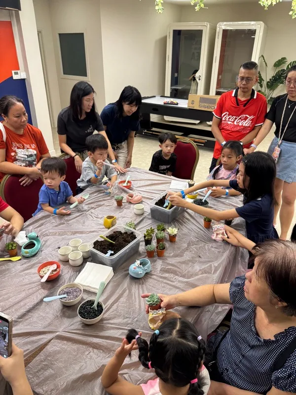 Guests building terrariums at a kids-at-work day